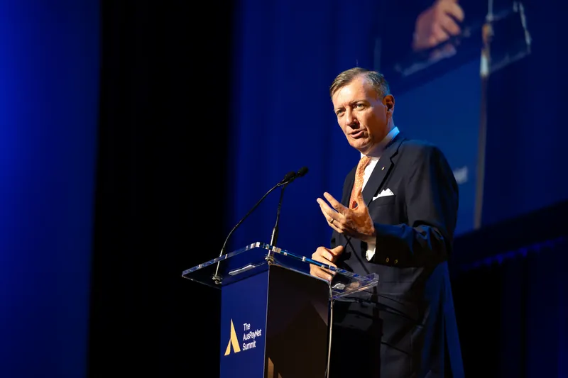 A speaker at the lectern during the Australian Payments Network summit