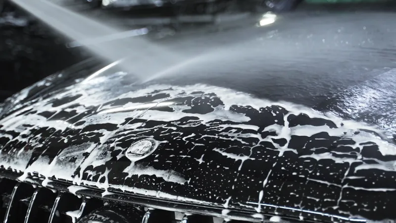 Coated black SUV under car park lights