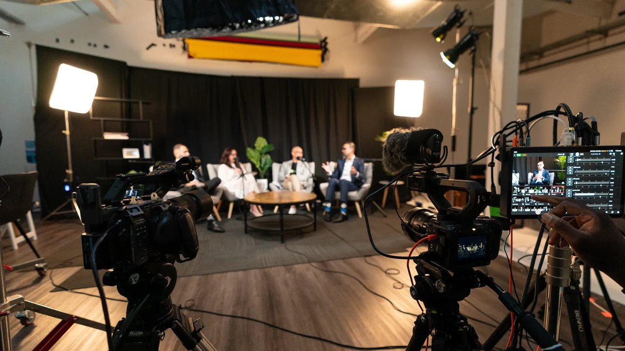 Cameras and lights set up around the Ryker podcast set during a recording.