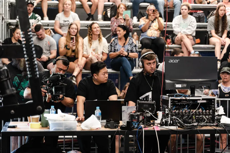 Production desk in front of the crowd at a powerlifting event