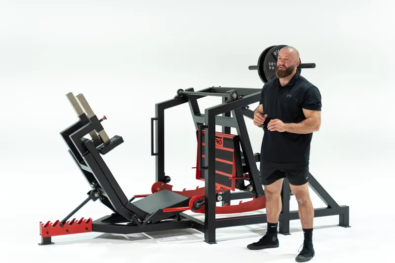 PHD Strength Hip Press on a white background with an athlete beside it