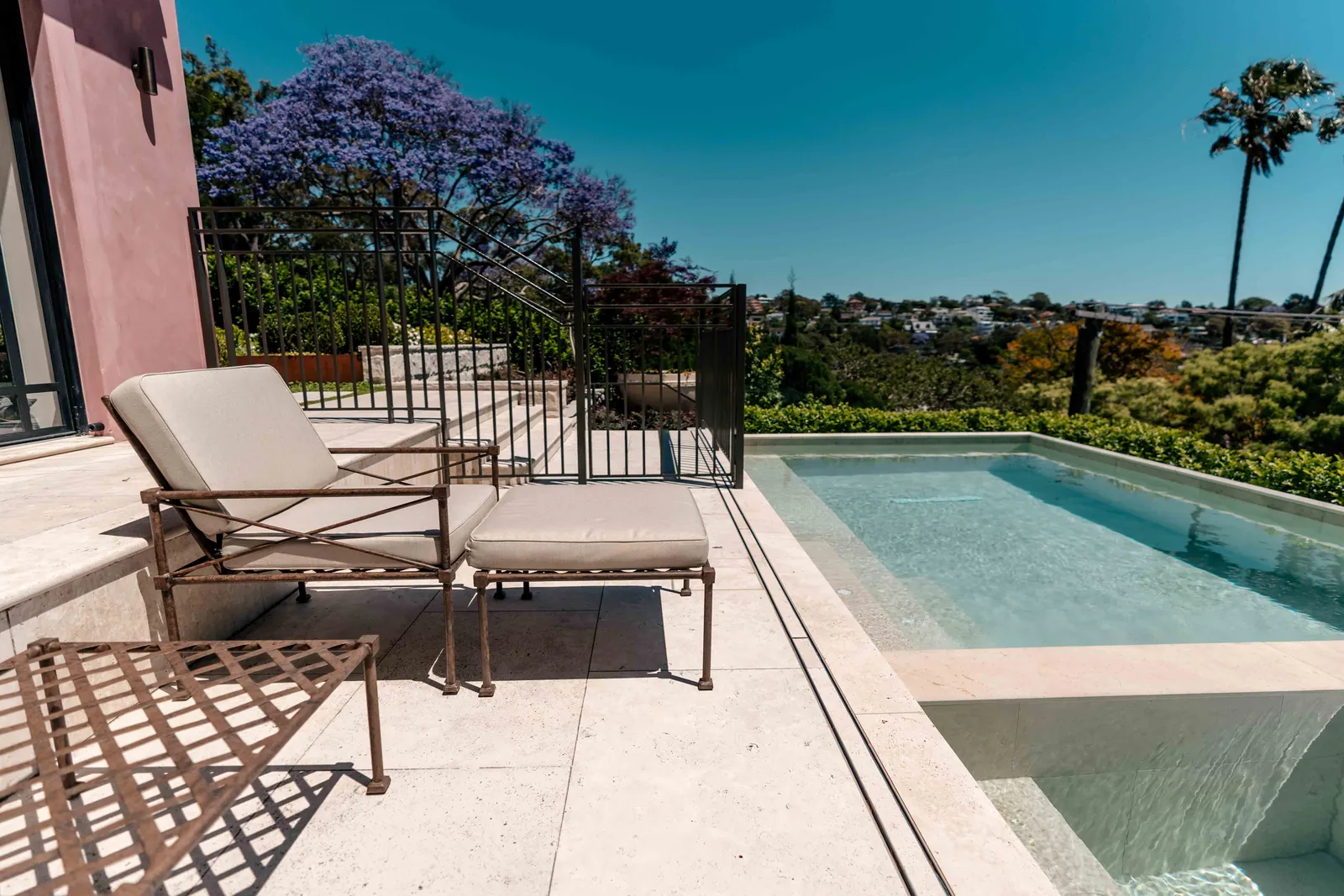 Outdoor furniture by a pool on a Yardware location shoot